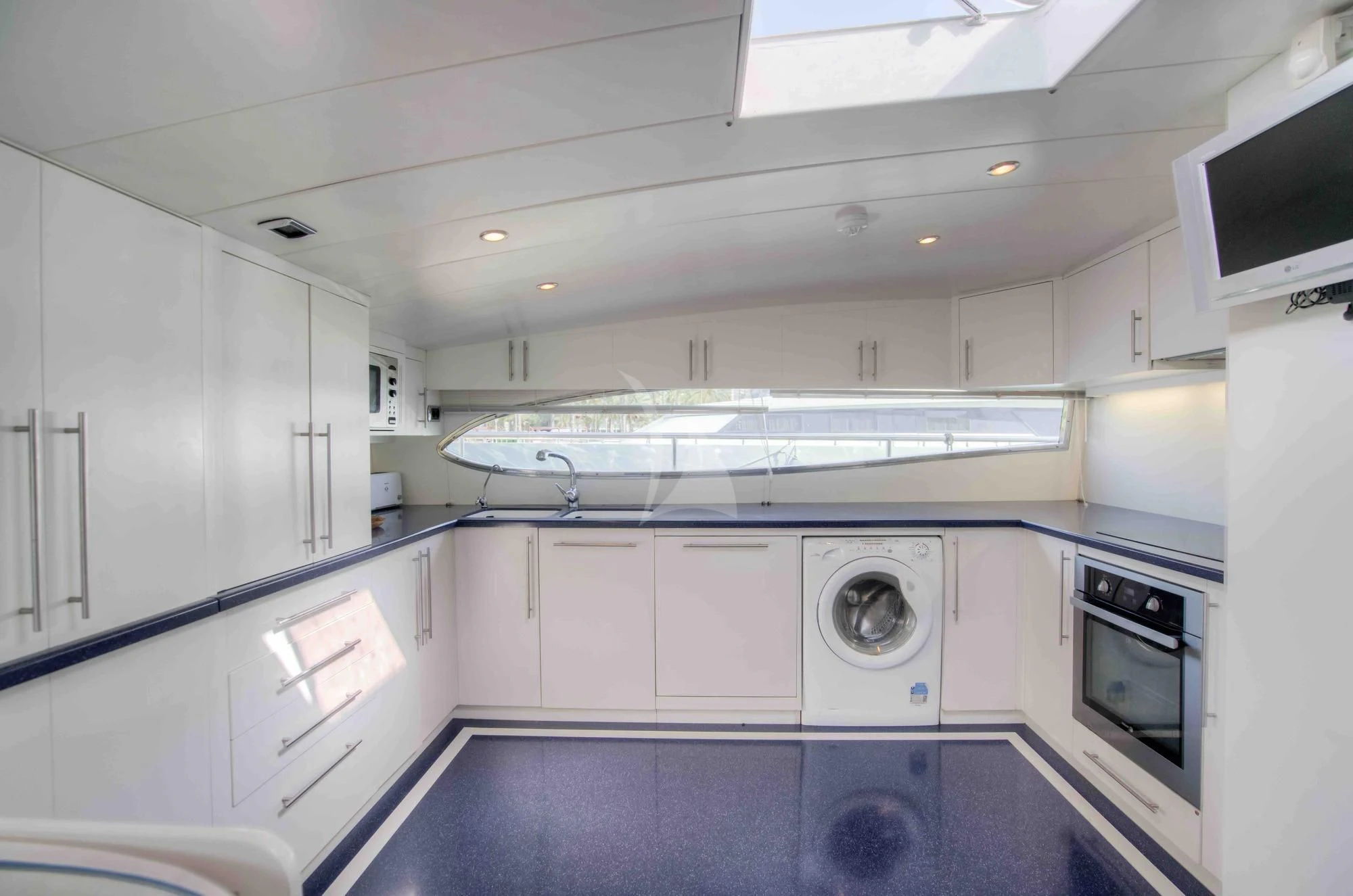 a kitchen with white cabinets aboard KIAWAH II Yacht for Sale
