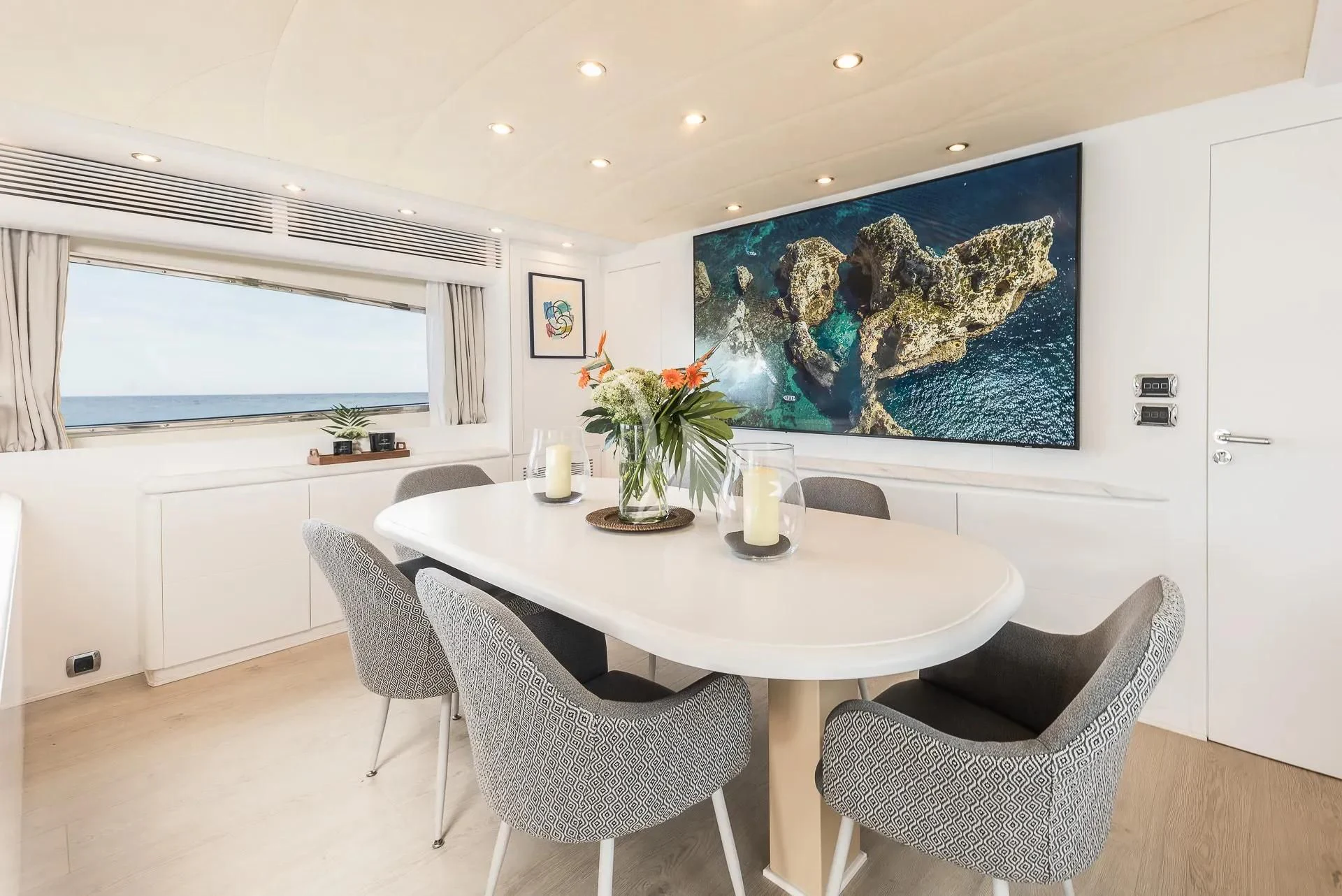 a white dining table with a white table and chairs aboard KIAWAH II Yacht for Sale