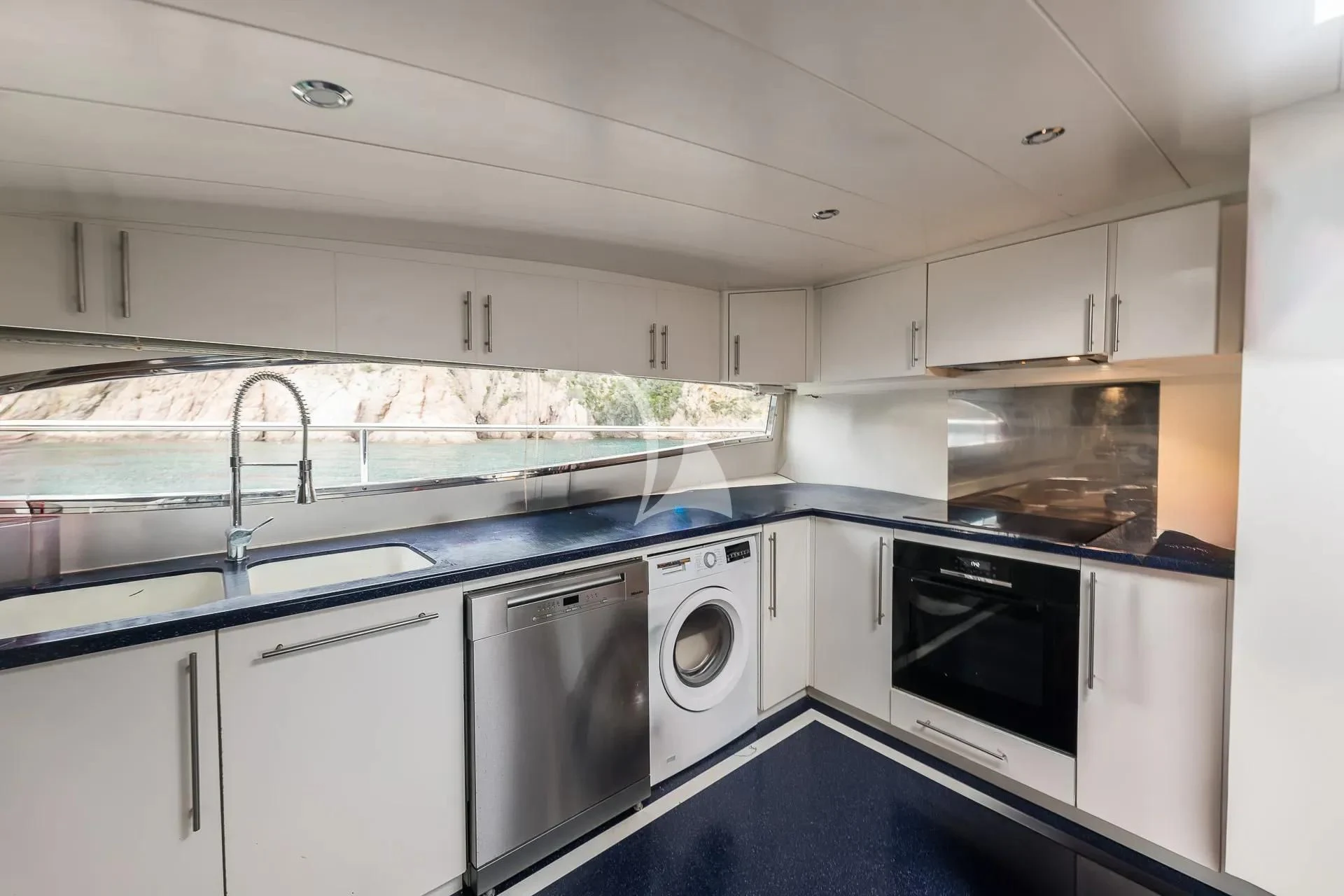 a kitchen with white cabinets aboard KIAWAH II Yacht for Sale