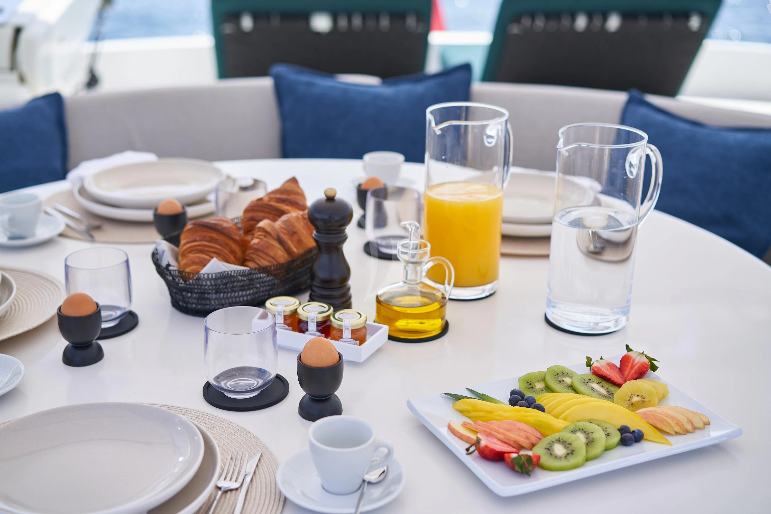 a table with food and drinks aboard KIAWAH II Yacht for Sale