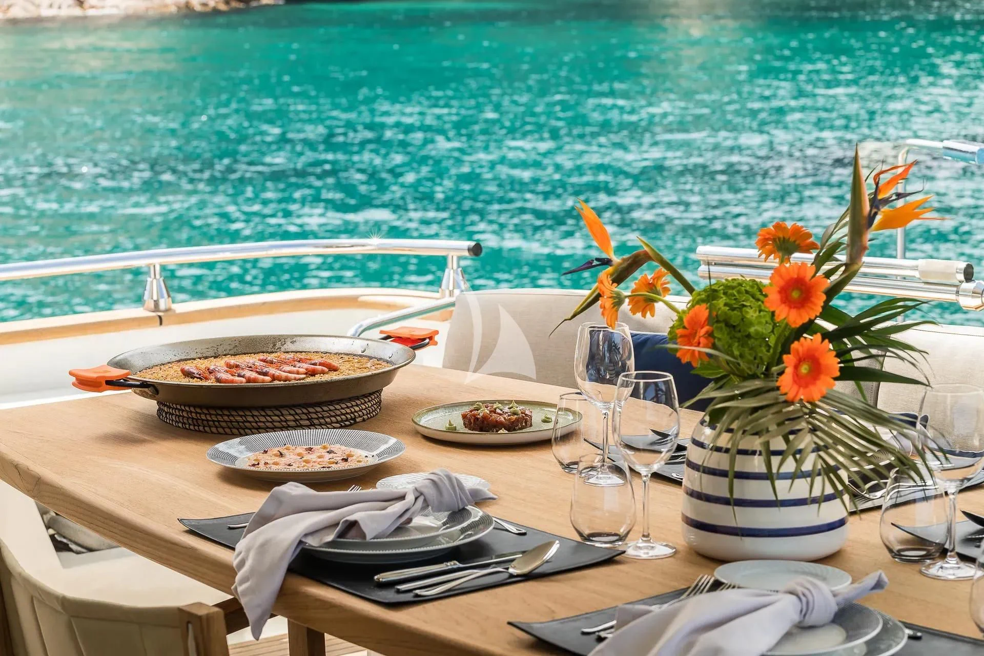 a table with plates and glasses on it aboard KIAWAH II Yacht for Sale