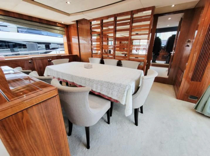 a table and chairs in a room aboard MY LILY Yacht for Sale