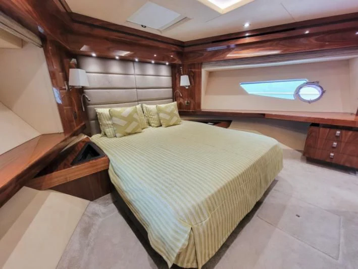 a bedroom with a bed and a desk aboard MY LILY Yacht for Sale