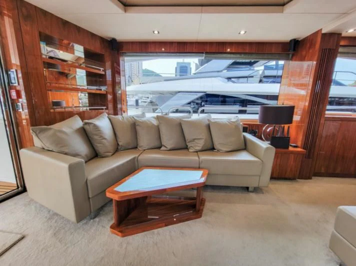 a living room with a couch and a table aboard MY LILY Yacht for Sale