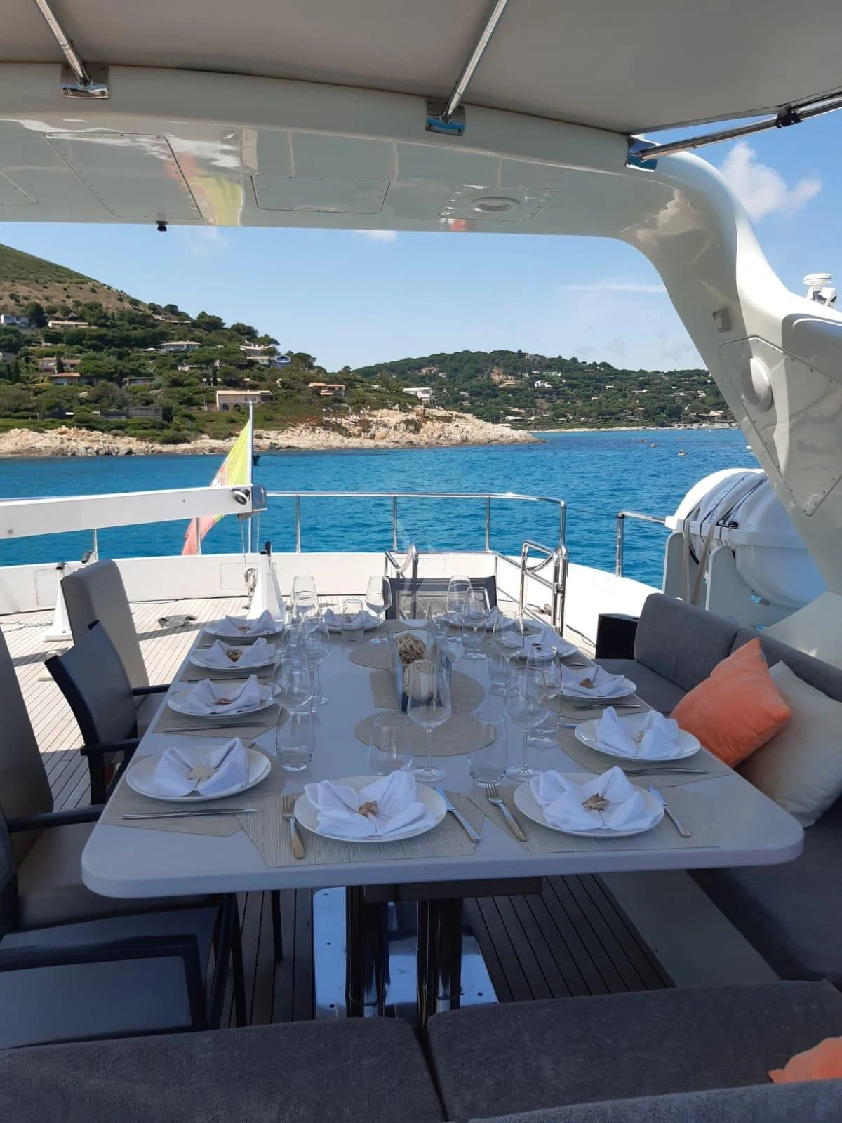 a table set for a dinner on a boat aboard YLANG YLANG Yacht for Sale