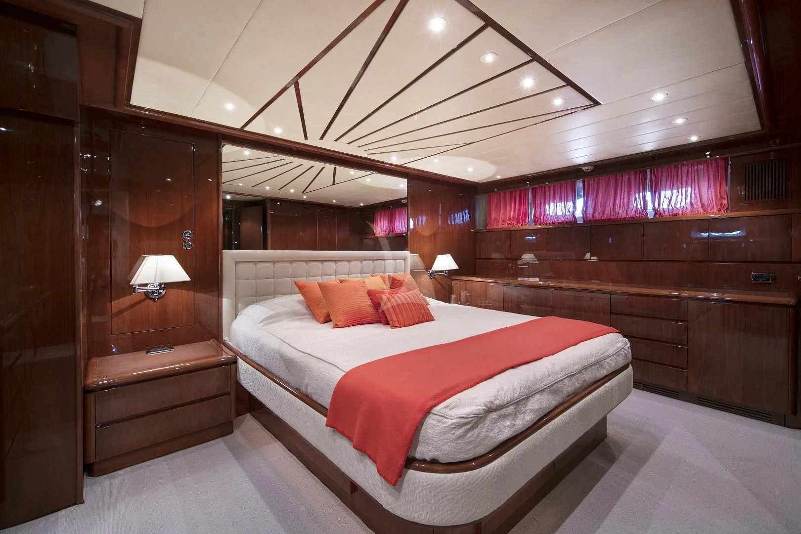 a room with a bed and a wood wall aboard YLANG YLANG Yacht for Sale