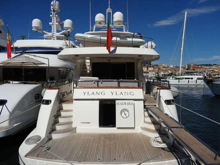 a boat docked at a pier aboard YLANG YLANG Yacht for Sale