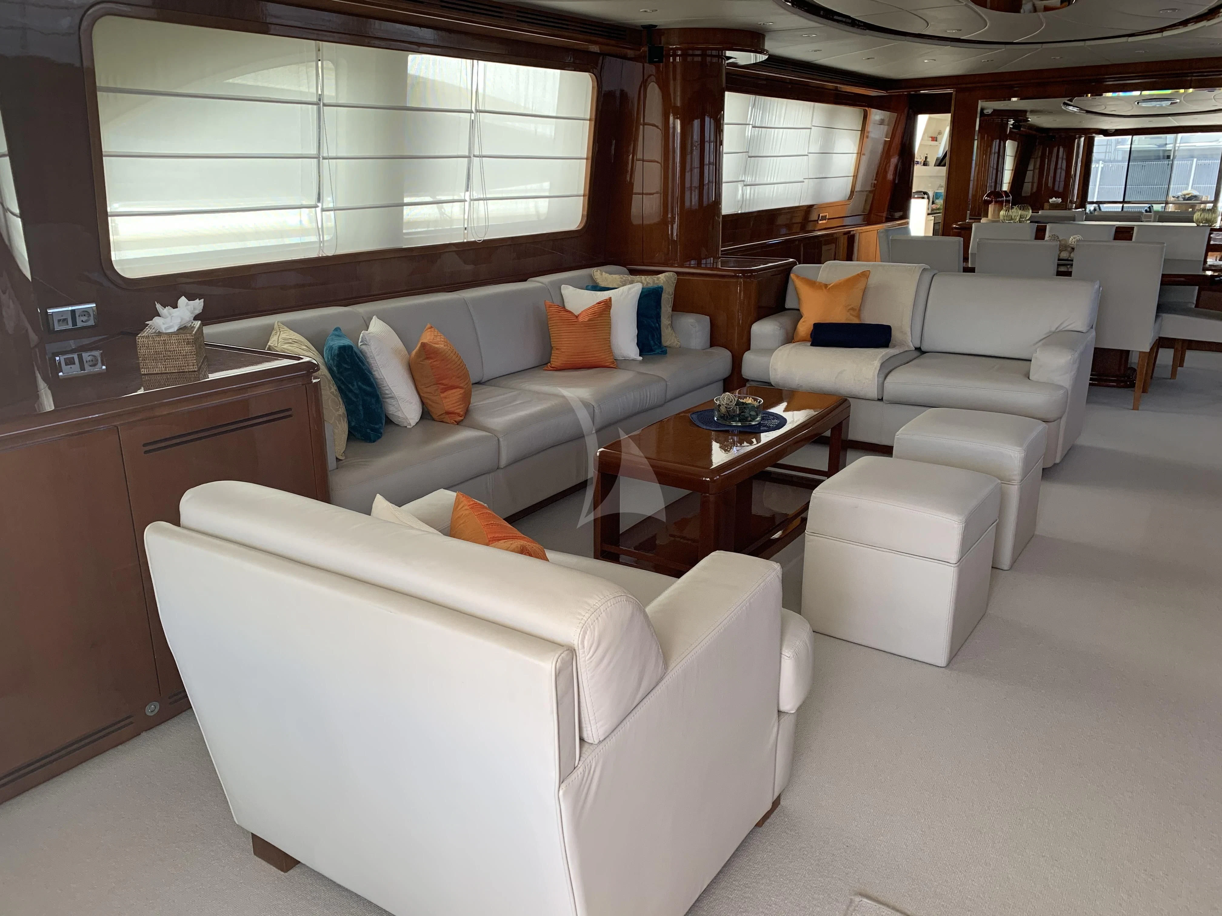 a living room with white furniture aboard YLANG YLANG Yacht for Sale