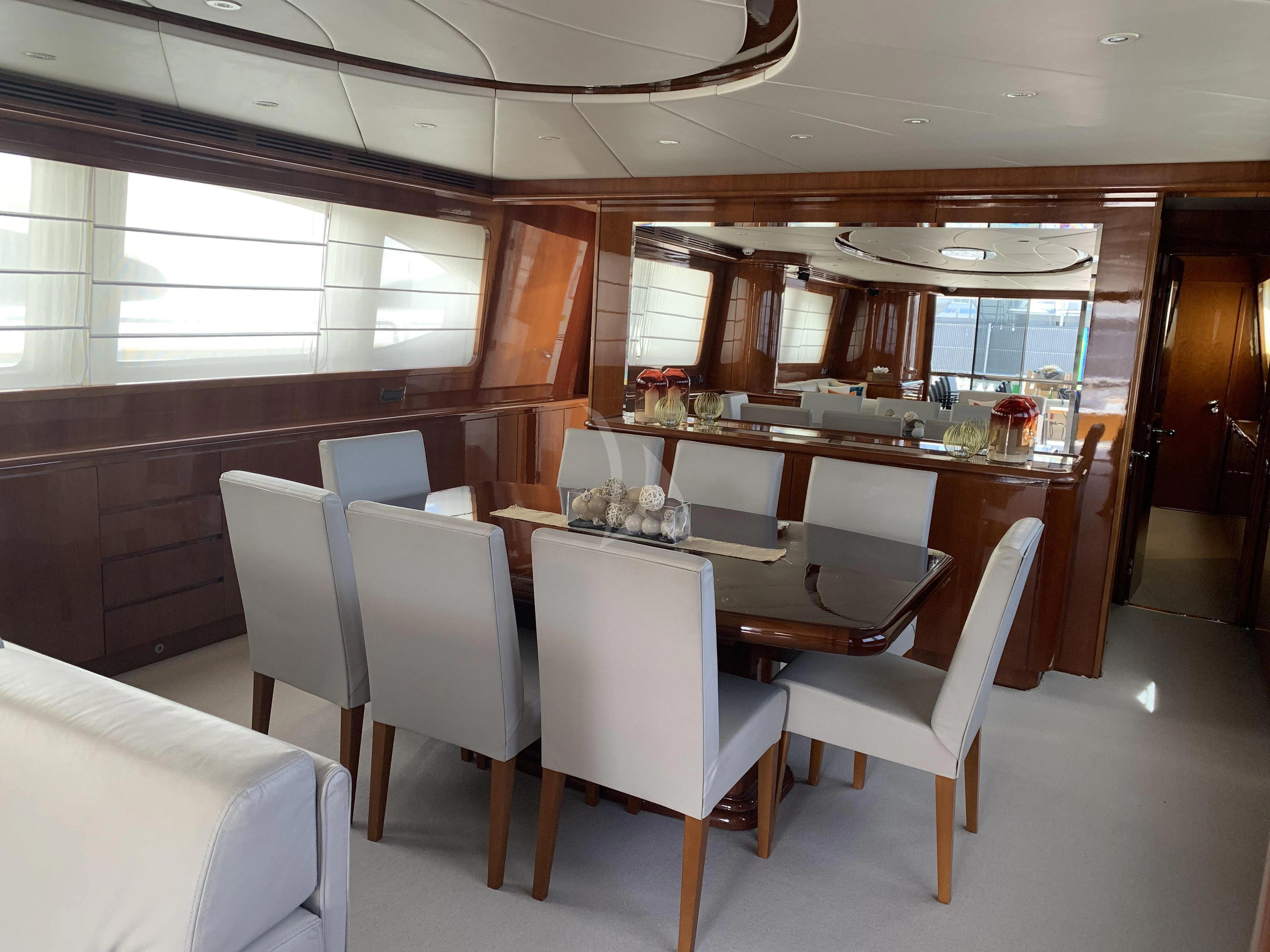 a restaurant with a table and chairs aboard YLANG YLANG Yacht for Sale