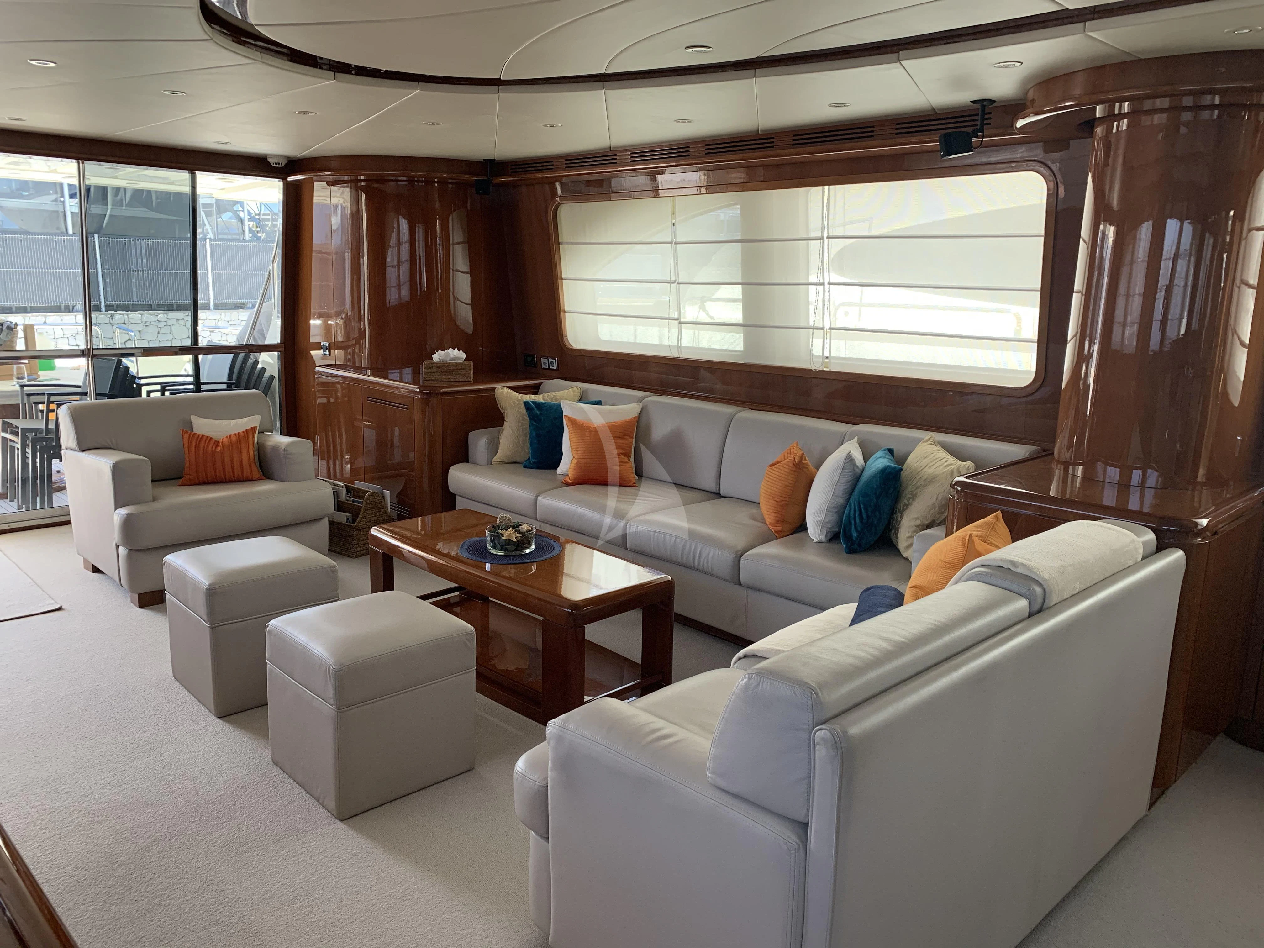 a living room with a couch and a table aboard YLANG YLANG Yacht for Sale