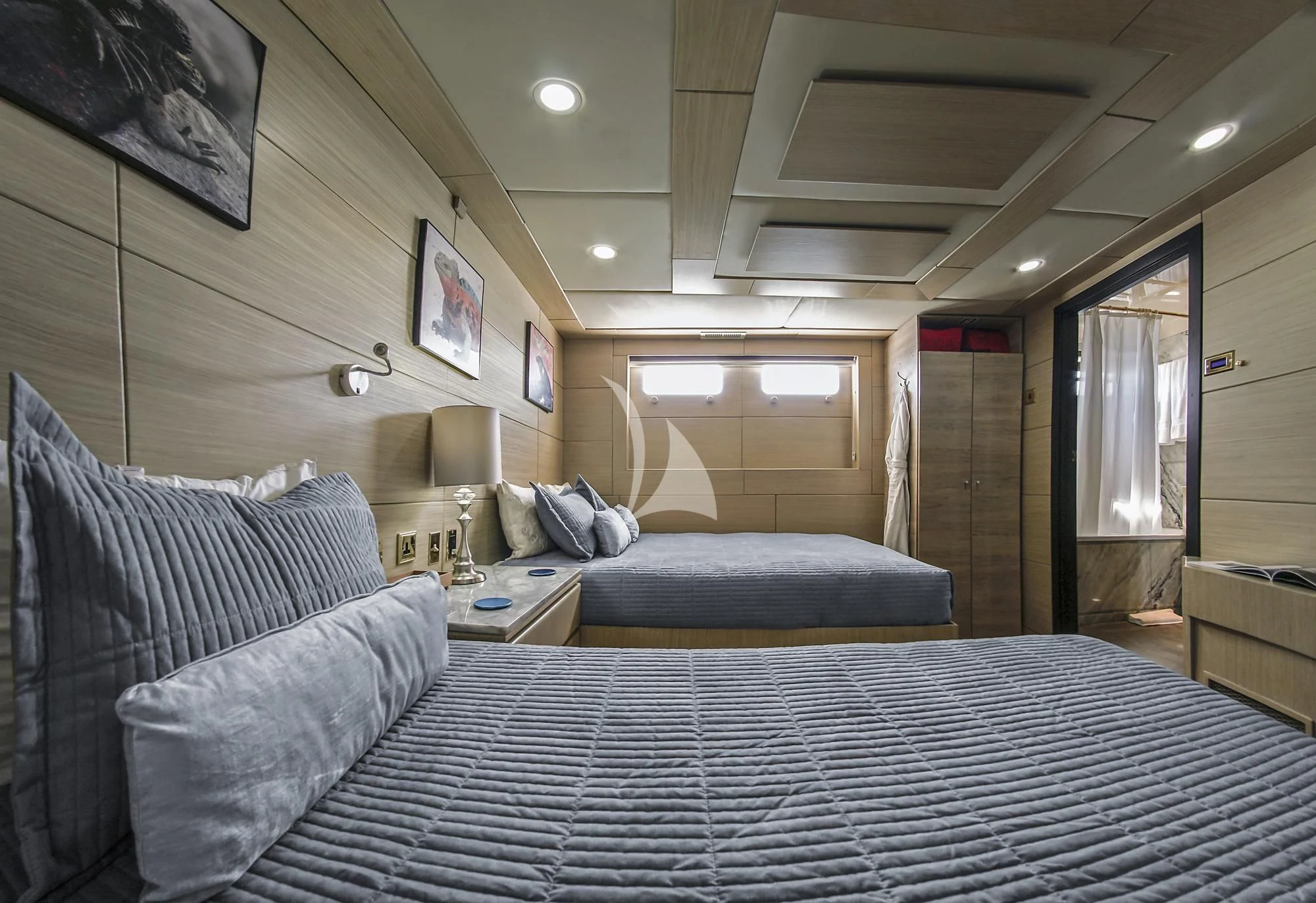 a couple of beds in a hotel room aboard M/Y PASSION Yacht for Sale
