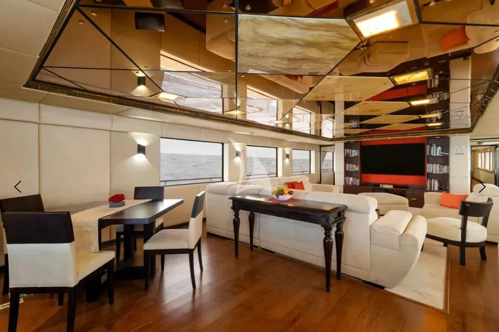 a room with tables and chairs aboard M/Y PASSION Yacht for Sale