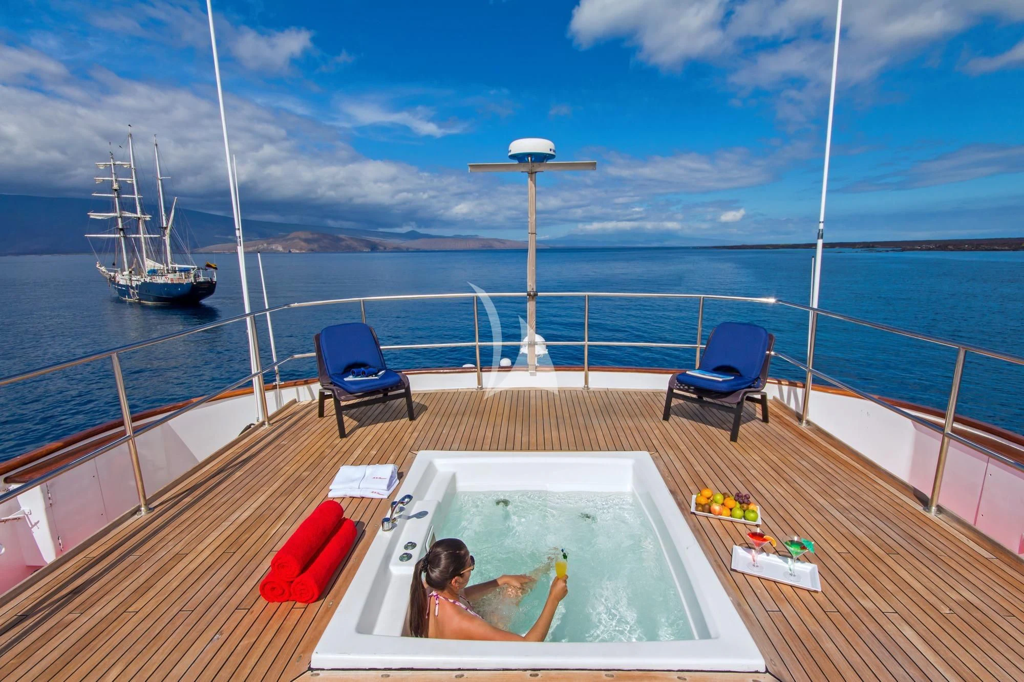 a person sitting on a chair on a deck looking out over the ocean aboard M/Y PASSION Yacht for Sale