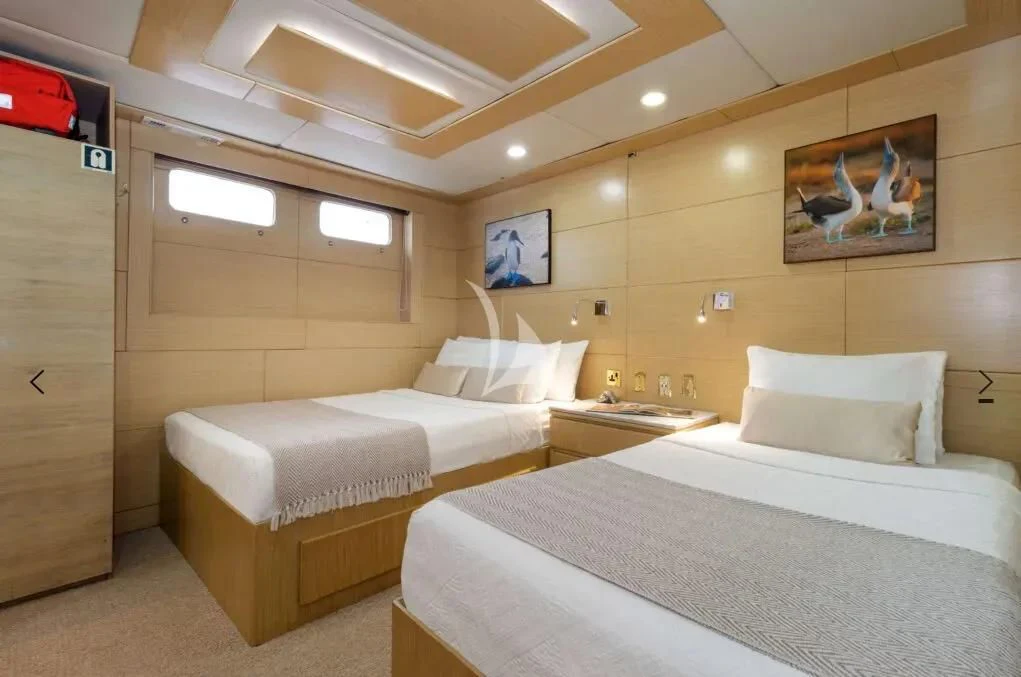 a room with two beds aboard M/Y PASSION Yacht for Sale