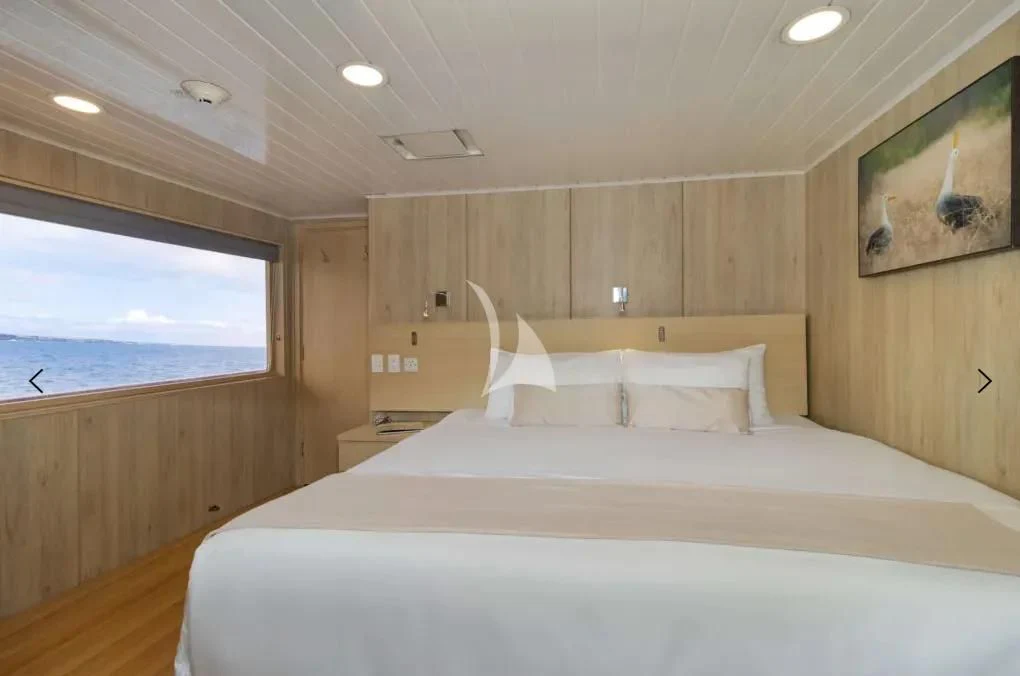 a bed in a room aboard M/Y PASSION Yacht for Sale