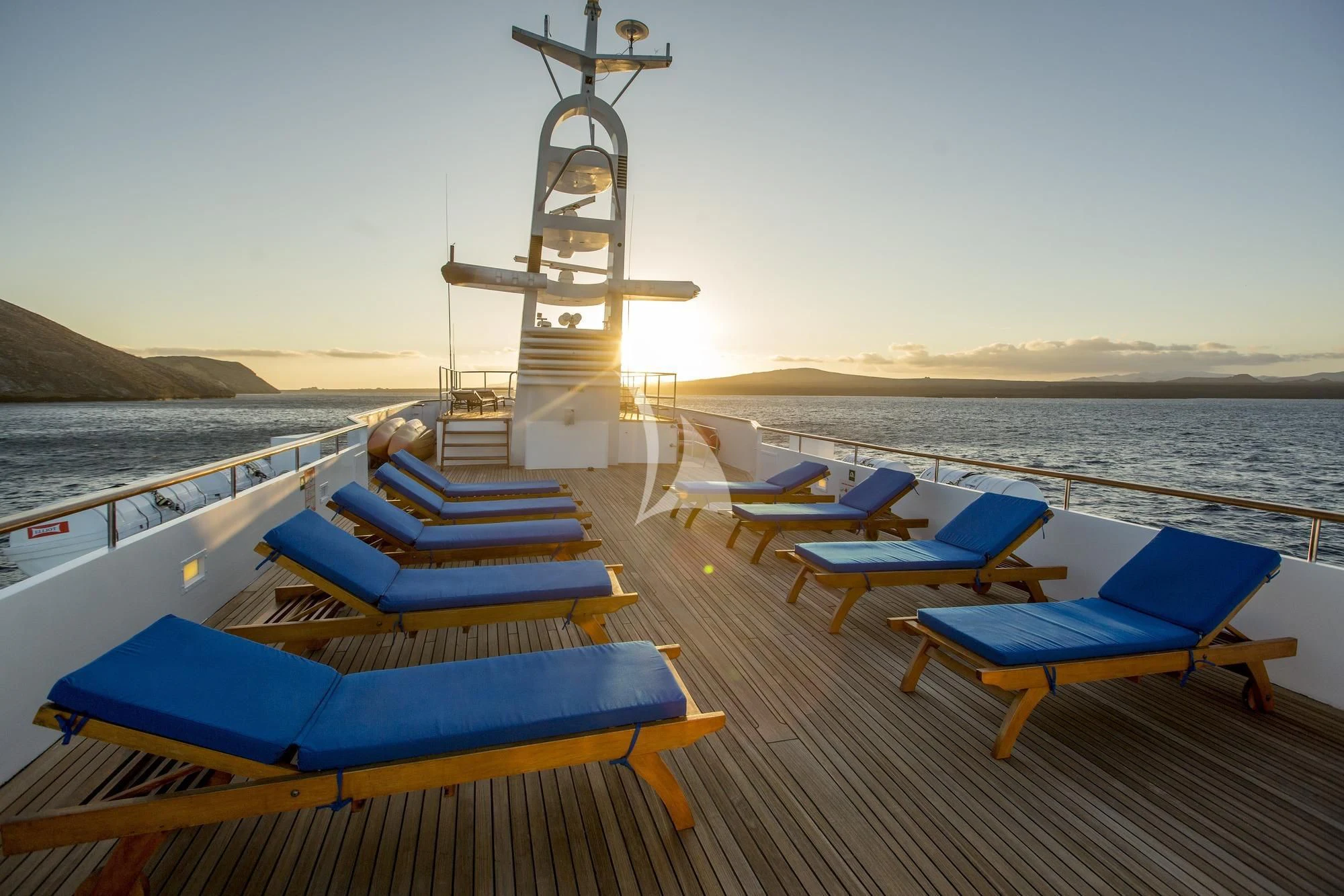 a deck with a large windmill in the background aboard M/Y PASSION Yacht for Sale