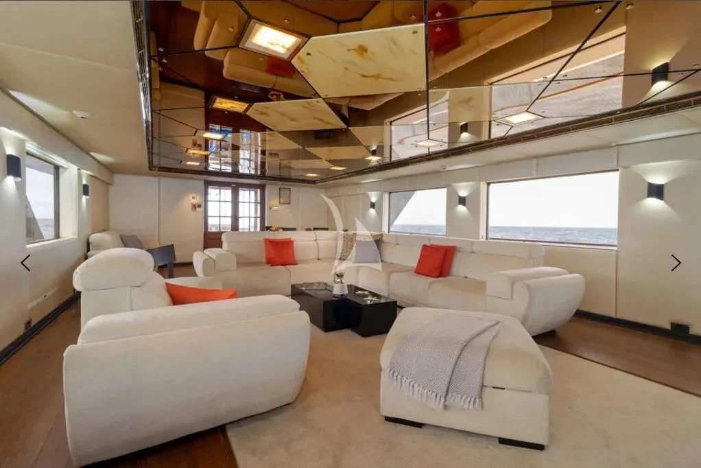 a room with couches and a table aboard M/Y PASSION Yacht for Sale