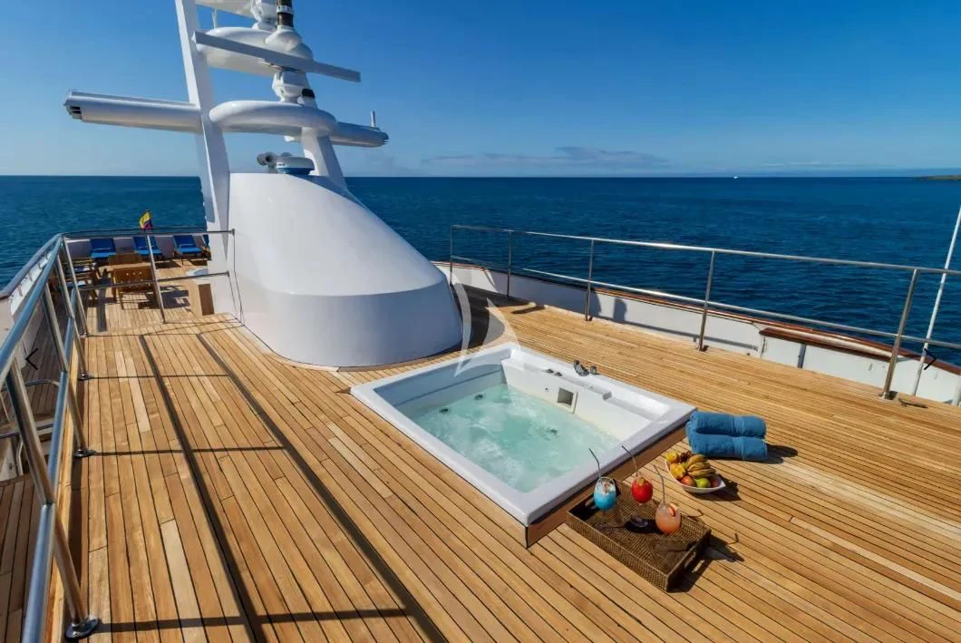 a deck with a pool and a boat on it aboard M/Y PASSION Yacht for Sale