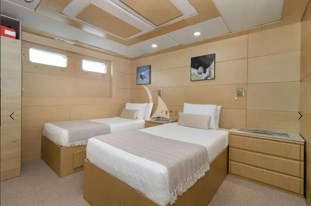 a room with two beds aboard M/Y PASSION Yacht for Sale