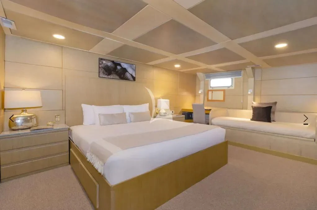 a room with a couple of beds aboard M/Y PASSION Yacht for Sale