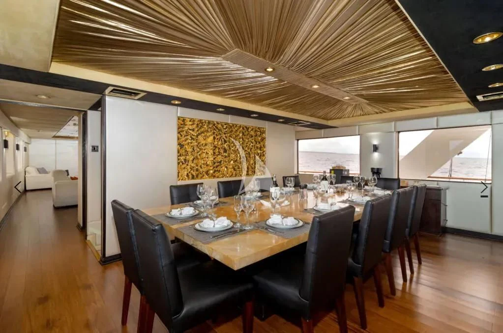 a large dining room with a large table and chairs aboard M/Y PASSION Yacht for Sale