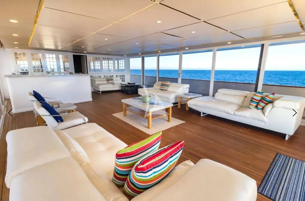a living room with a large window aboard M/Y PASSION Yacht for Sale