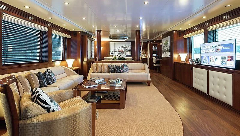 a living room with a couch and a coffee table aboard W EXPLORER Yacht for Sale