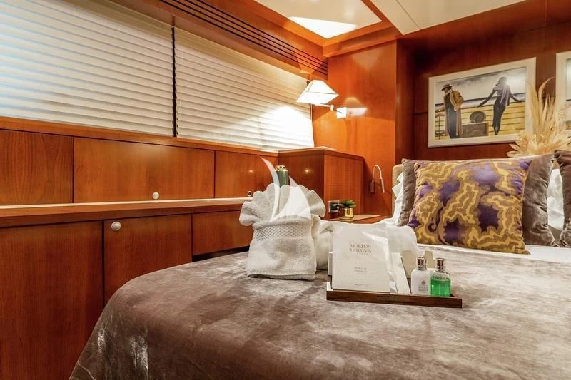 a room with a bed and a table aboard W EXPLORER Yacht for Sale