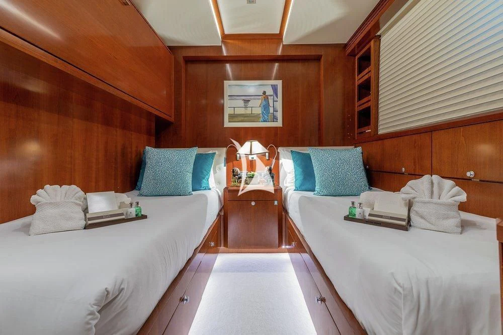 a room with beds and a mirror aboard W EXPLORER Yacht for Sale