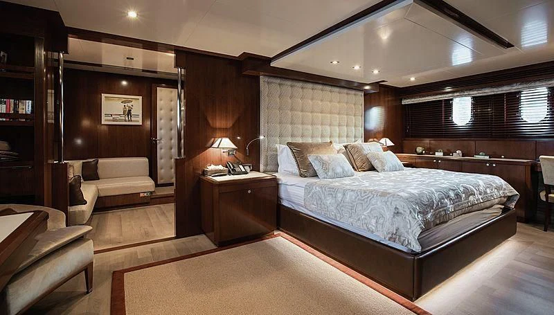 a large bedroom with a bed and a couch aboard W EXPLORER Yacht for Sale