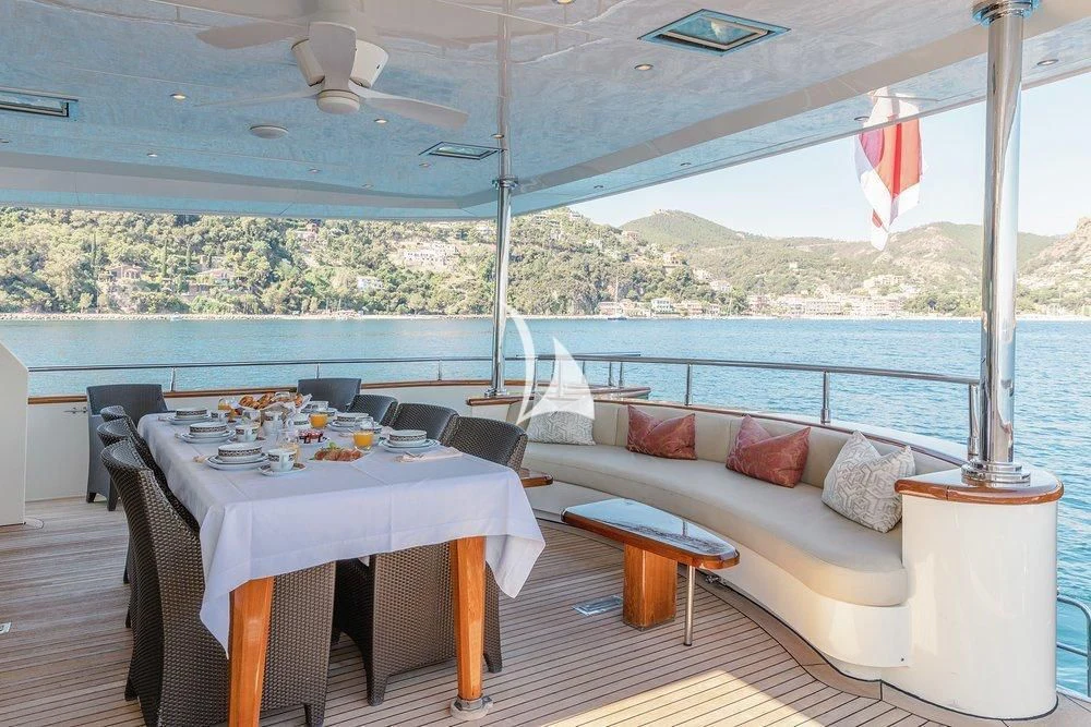 a table and chairs on a deck aboard W EXPLORER Yacht for Sale