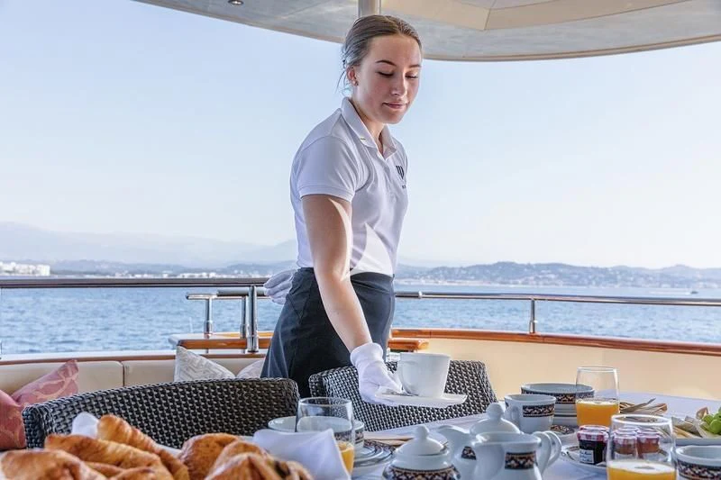 a man in a white shirt aboard W EXPLORER Yacht for Sale
