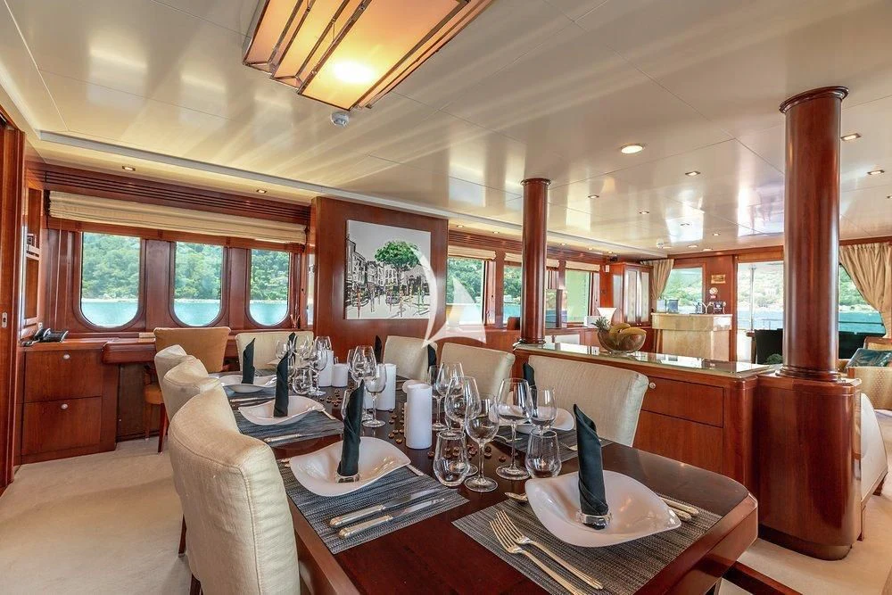 a dining room with a table set aboard W EXPLORER Yacht for Sale