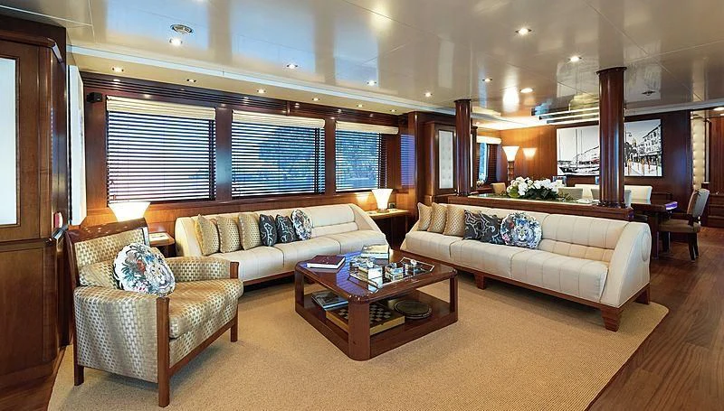 a living room with a couch and a coffee table aboard W EXPLORER Yacht for Sale