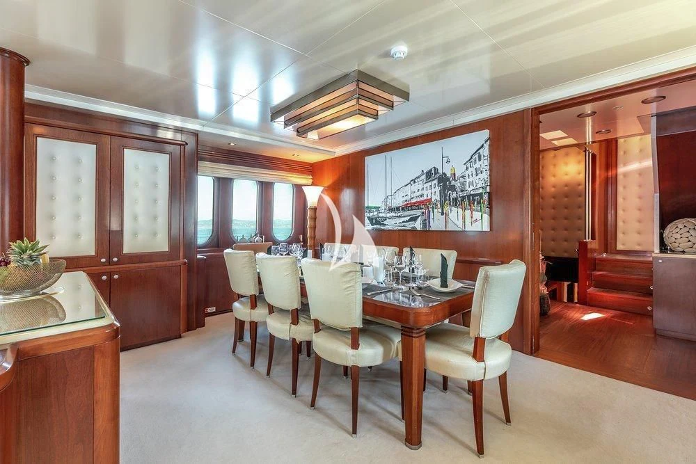 a dining room with a table and chairs aboard W EXPLORER Yacht for Sale