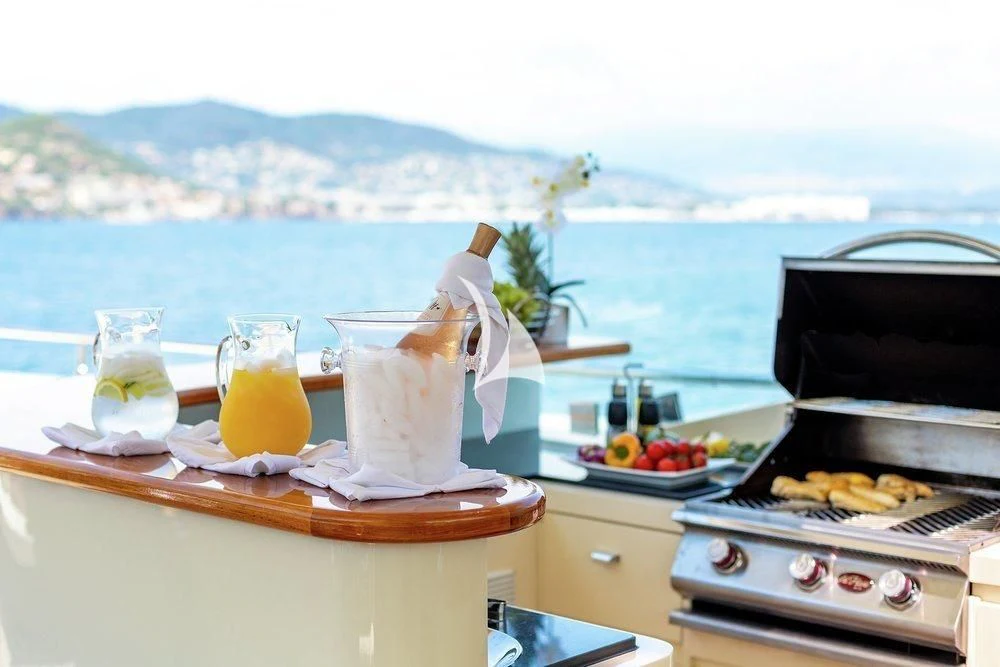 a table with food and drinks on it aboard W EXPLORER Yacht for Sale