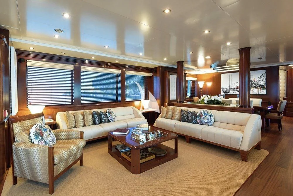 a living room with a couch and a coffee table aboard W EXPLORER Yacht for Sale