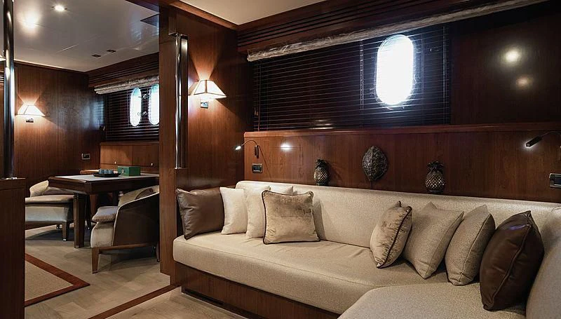 a living room with a couch and a table aboard W EXPLORER Yacht for Sale