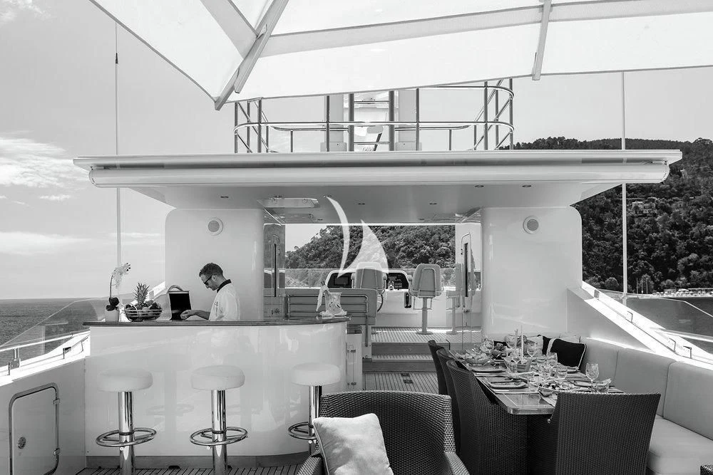 a black and white photo of a kitchen and dining area aboard W EXPLORER Yacht for Sale