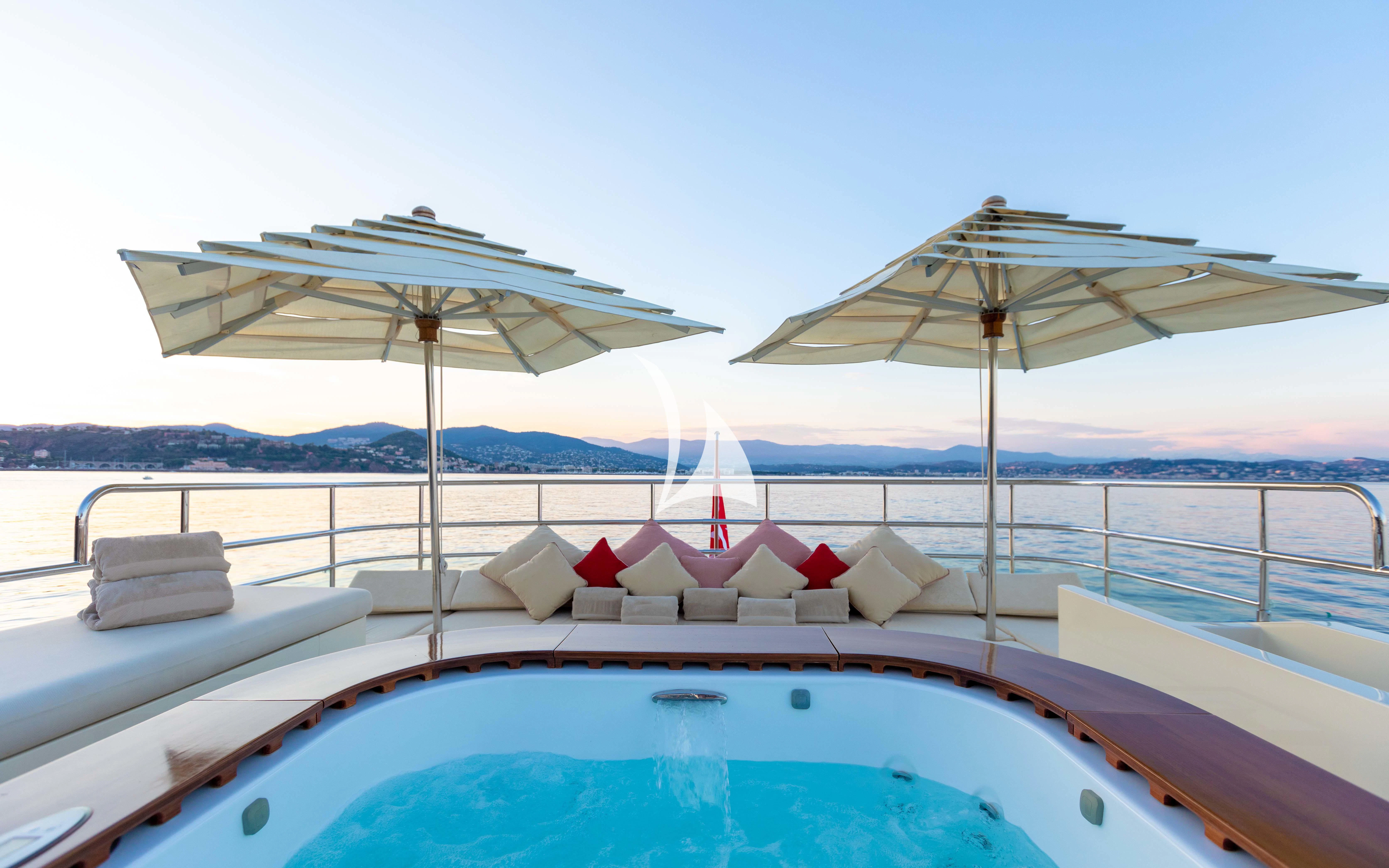 a pool with umbrellas and chairs on it aboard W EXPLORER Yacht for Sale