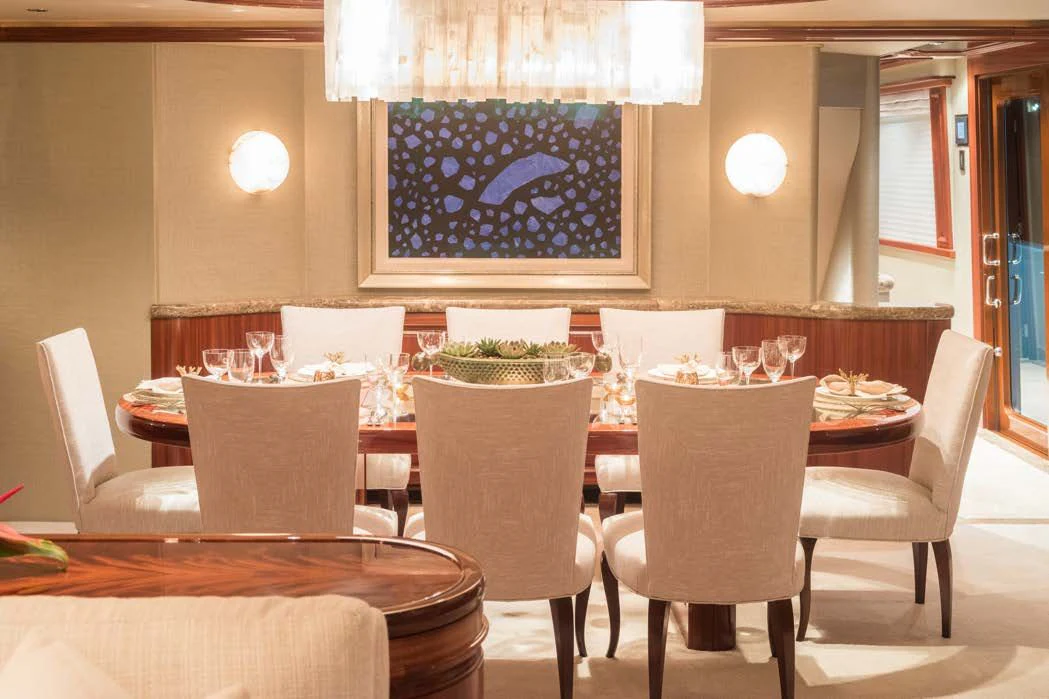 a dining room table with chairs and a large chandelier aboard TRUST FUN Yacht for Sale