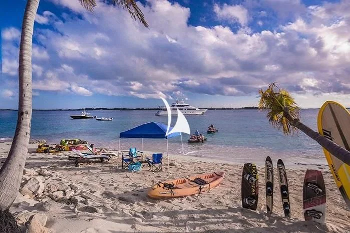 a beach with chairs and umbrellas aboard TRUST FUN Yacht for Sale