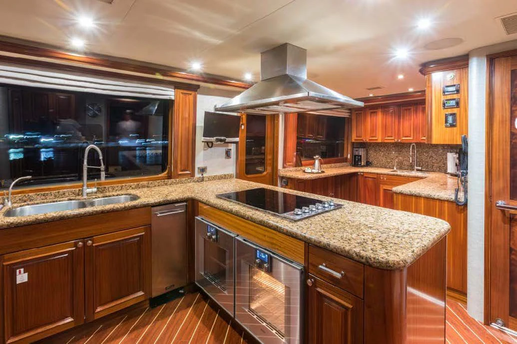 a kitchen with wooden cabinets aboard TRUST FUN Yacht for Sale
