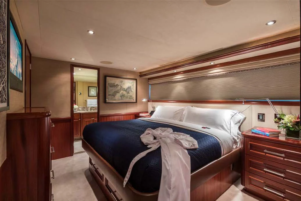 a bedroom with a bed and a television aboard TRUST FUN Yacht for Sale