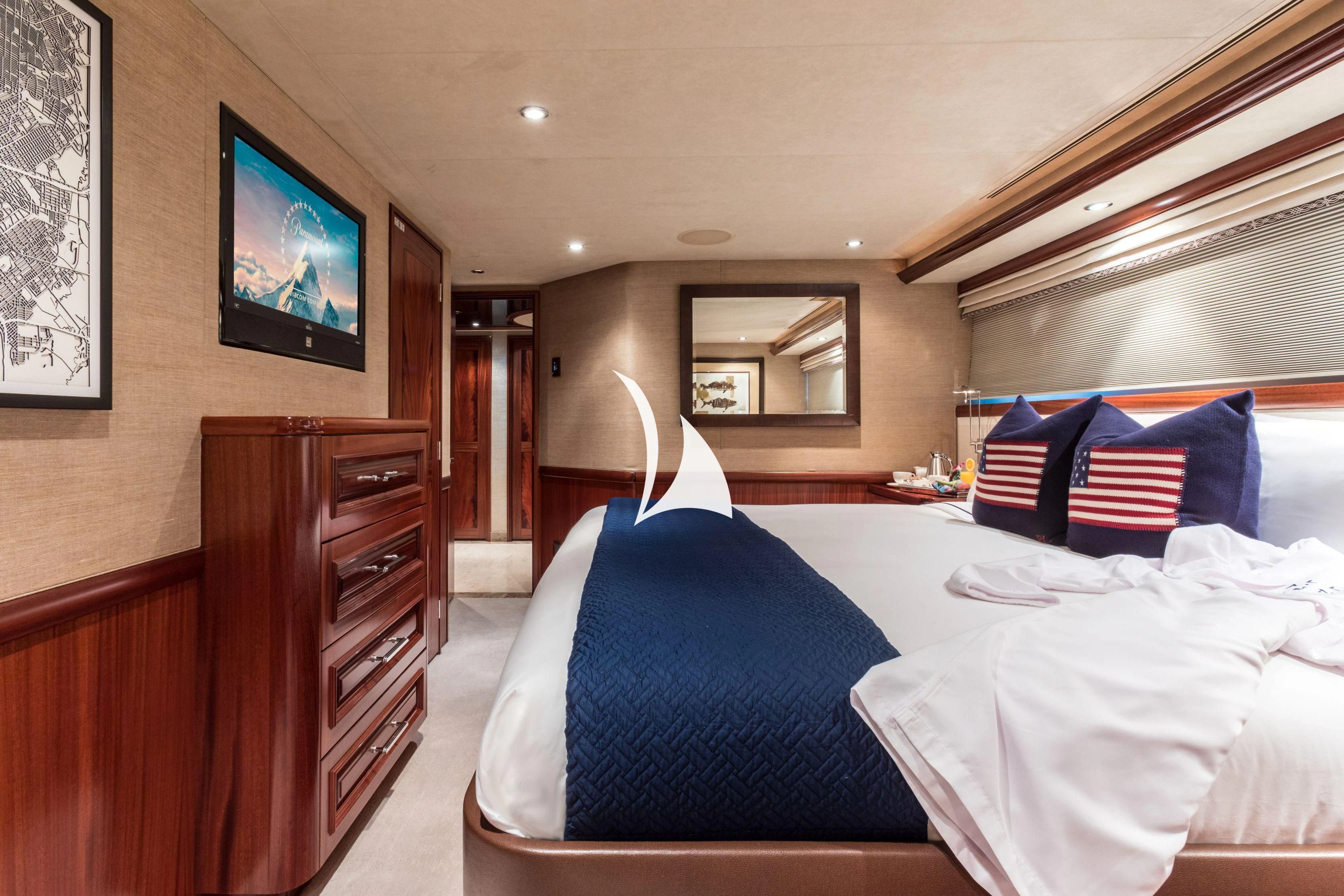 a bedroom with a bed and a television aboard TRUST FUN Yacht for Sale