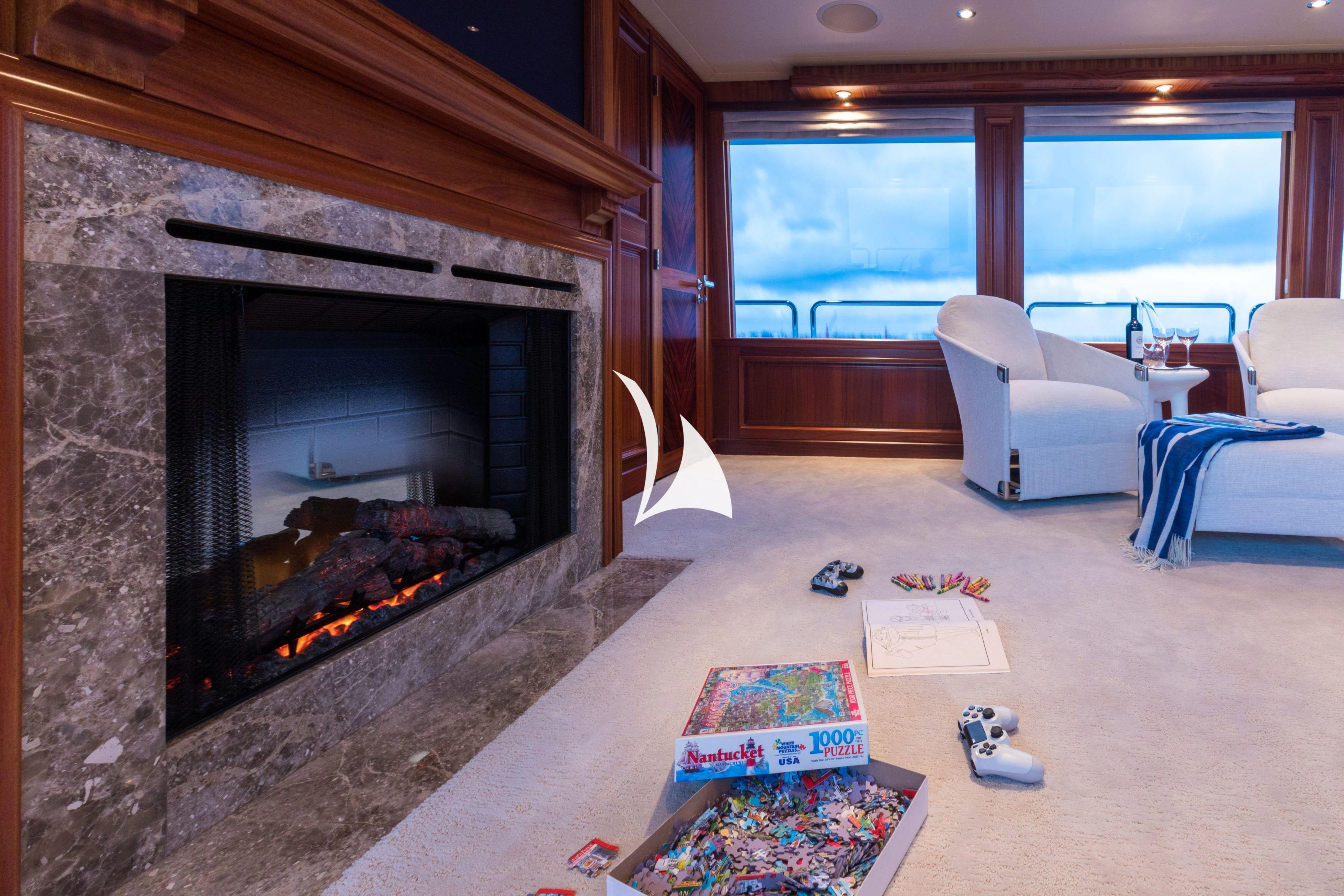 a living room with a fireplace aboard TRUST FUN Yacht for Sale