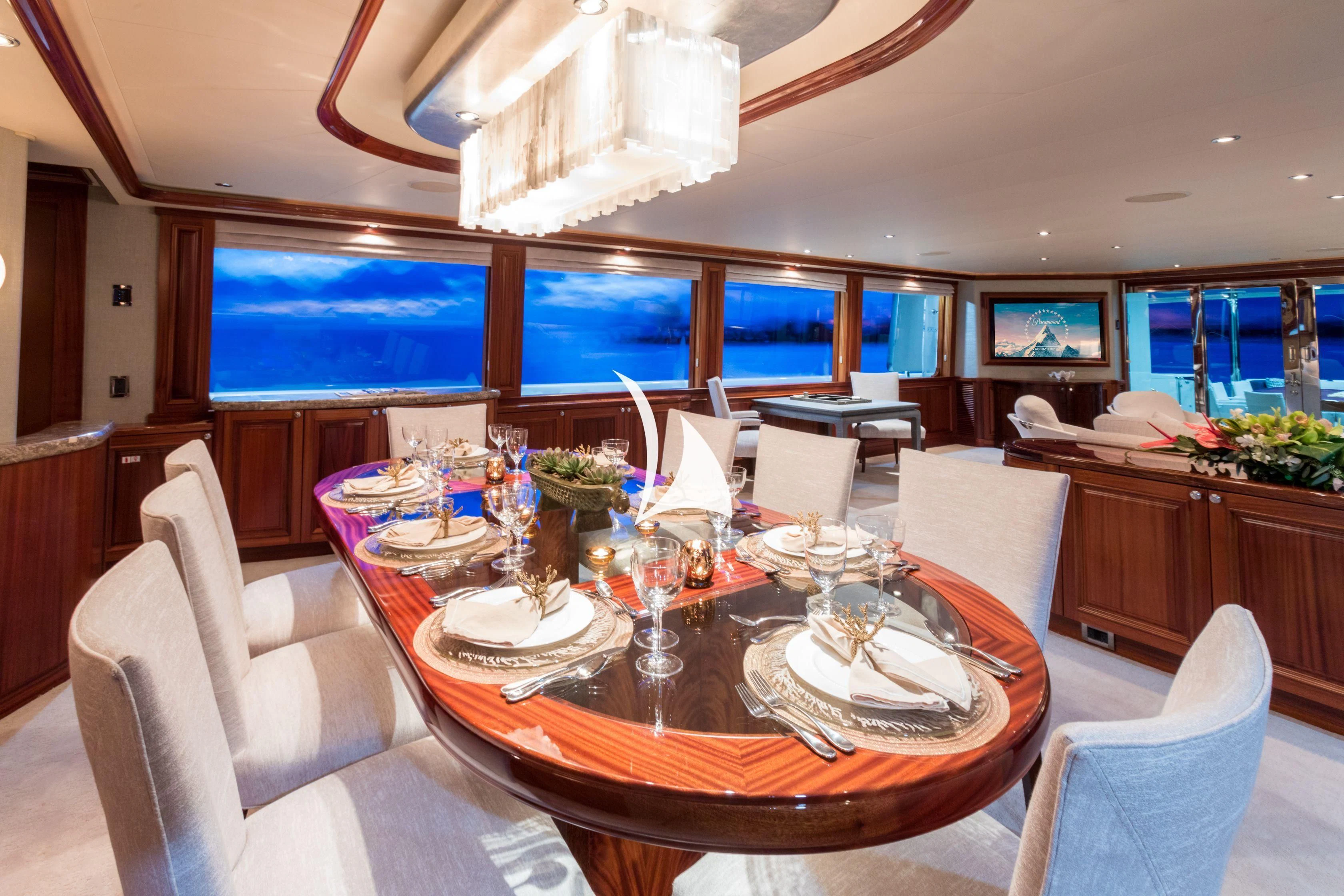 a dining table with plates and glasses aboard TRUST FUN Yacht for Sale