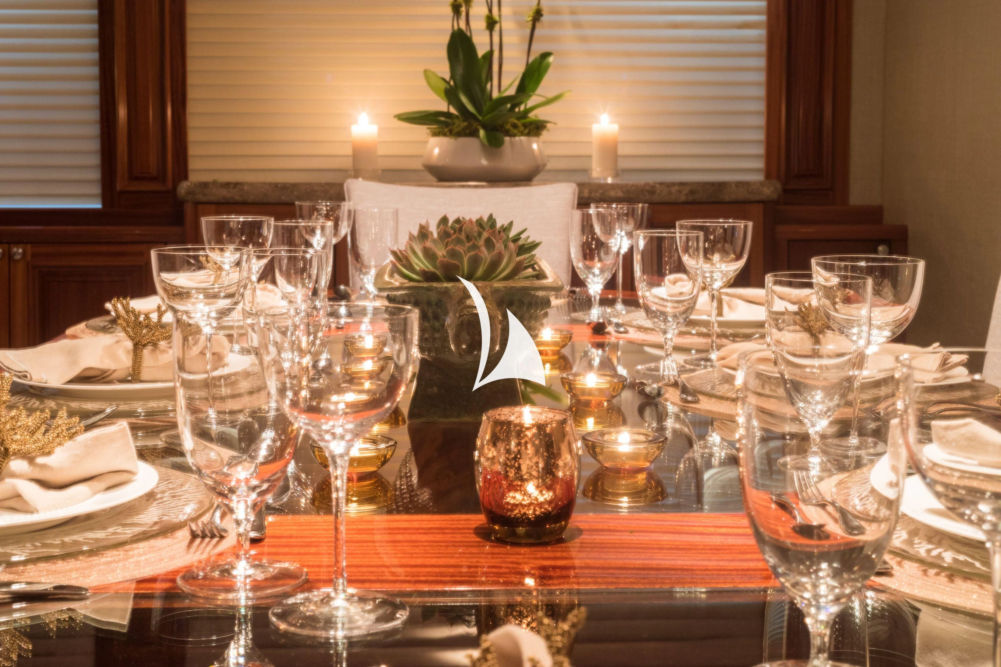 a table with many glasses and plates aboard TRUST FUN Yacht for Sale
