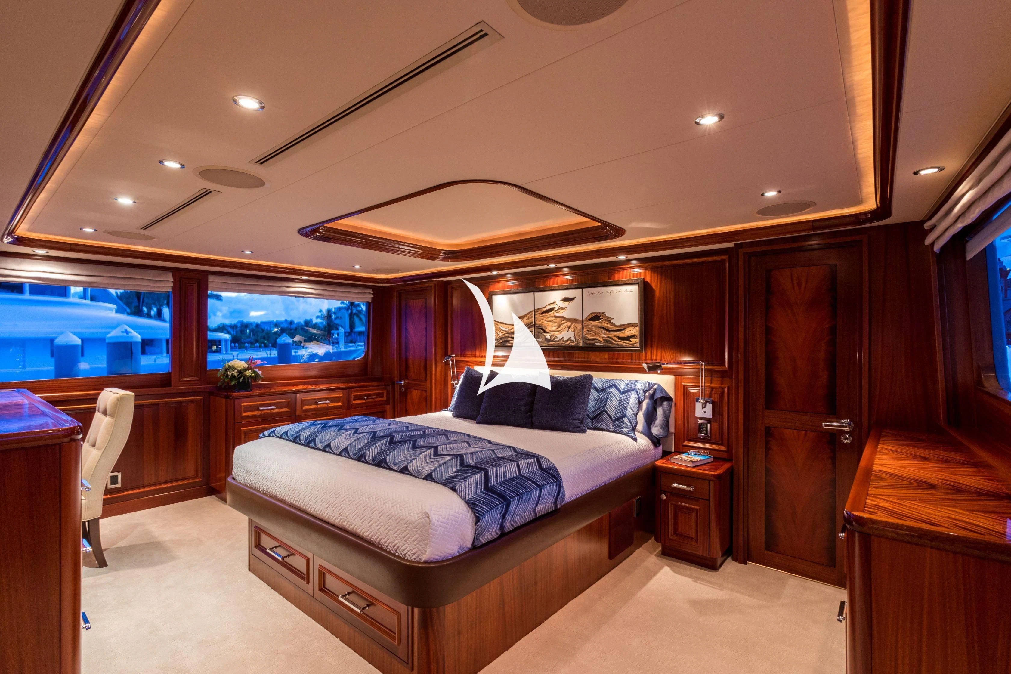 a bedroom with a bed and a wood cabinet aboard TRUST FUN Yacht for Sale