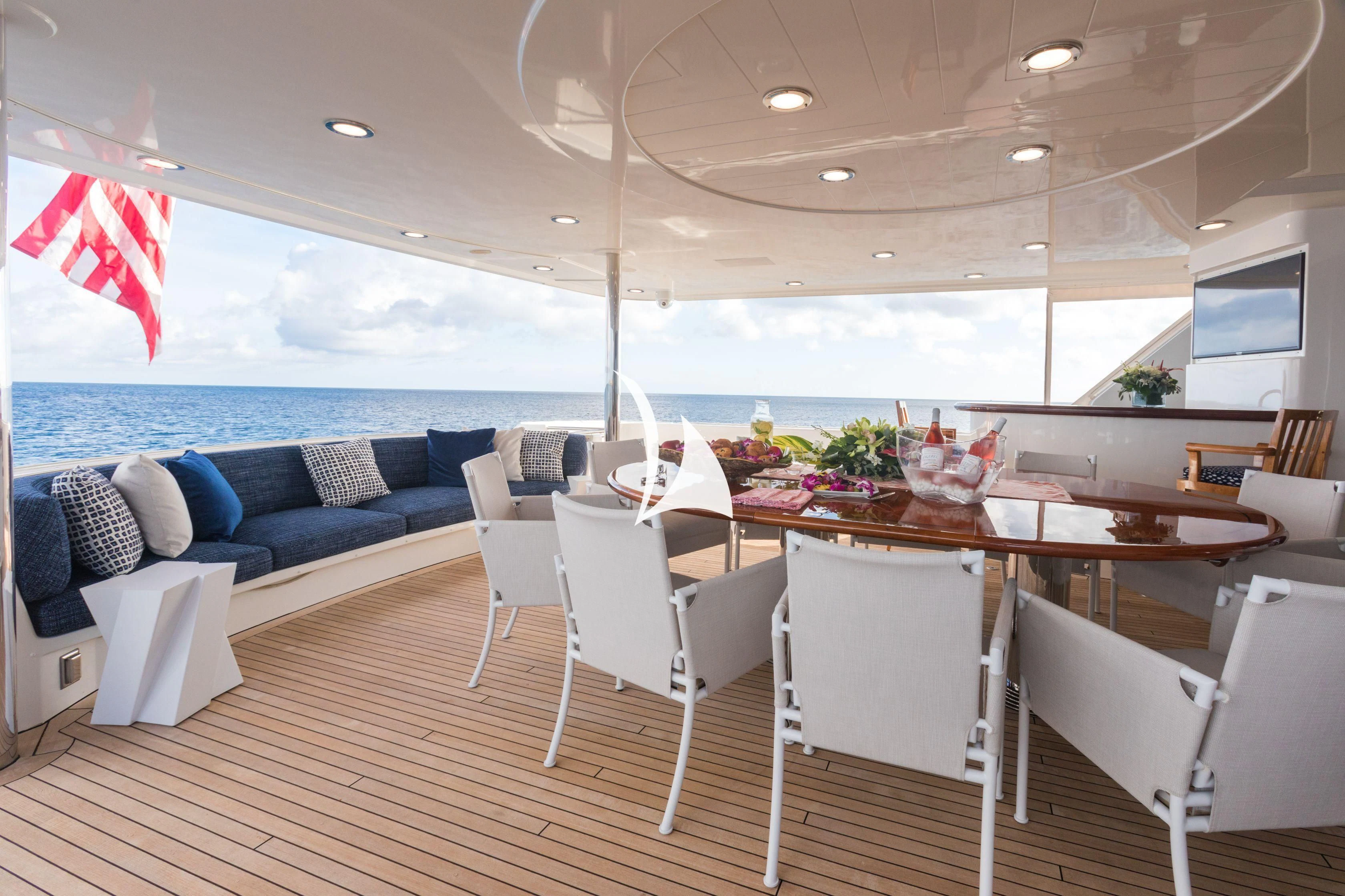 a room with a table chairs and a couch aboard TRUST FUN Yacht for Sale